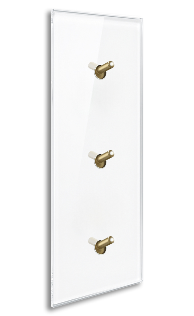 Modern illuminated design light switch in white glass optic with 3 brass toggle levers. YORK